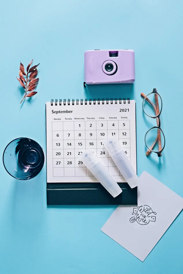 2021 Calendar with camera and eyeglasses in blue background