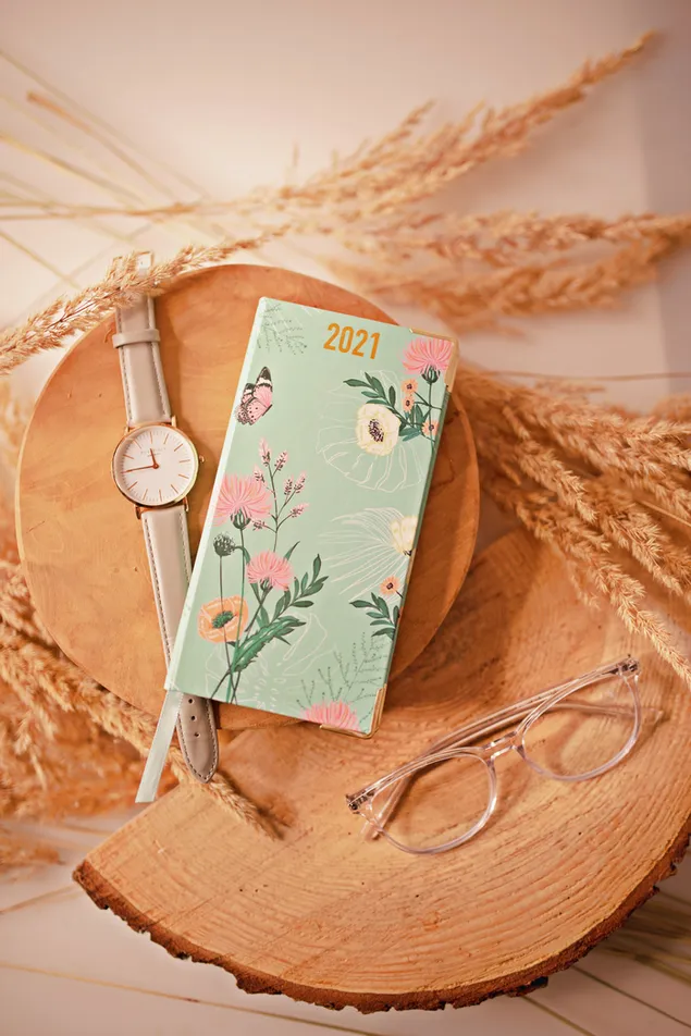 2021 green planner flower design with white watch and eyeglasses