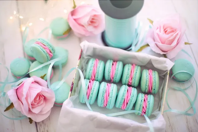 A box of light green and pink Macaroons with pink Roses 