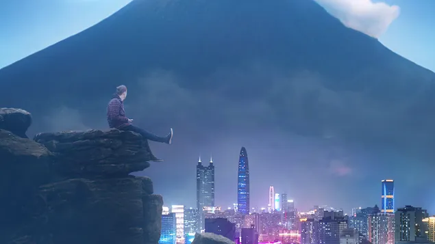 A boy sitting on the top of a mountain overlooking the mountain city 4K wallpaper