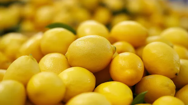 O grămadă veselă și răcoritoare de lămâi galbene strălucitoare 2K imagine de fundal