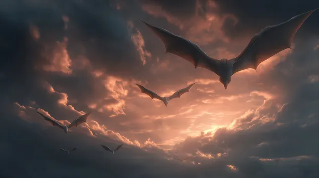 Stado mitycznych smoków lecące przez dramatyczne niebo o świcie 2K tapeta