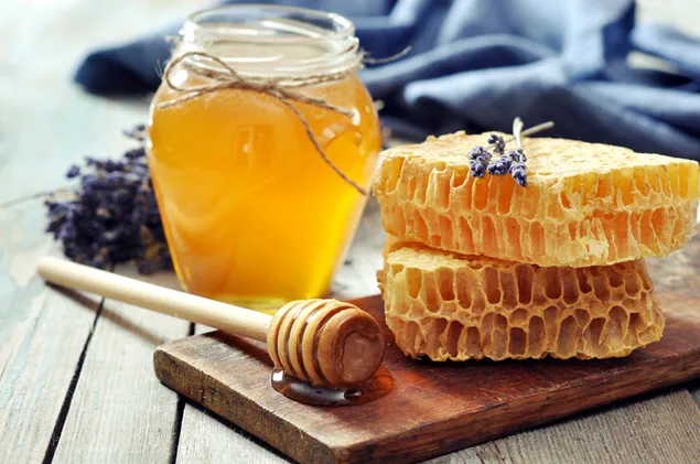 A jar of honey and a honeycomb 