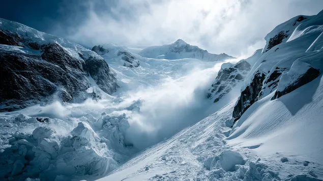una gran avalancha cae en cascada por una ladera de montana empinada y helada. descargar