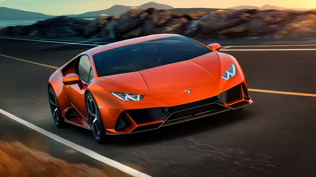 A state-of-the-art orange Lamborghini with its fast and powerful structure on the asphalt road