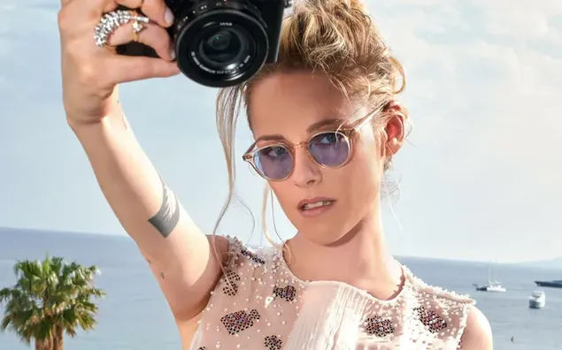 Актерката Кристен Стјуарт на одмор држејќи камера во рака 4K тапет