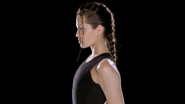 L'actriu nord-americana Angelina Jolie posa de costat amb un vestit esportiu negre sobre un fons negre. 2K fons de pantalla