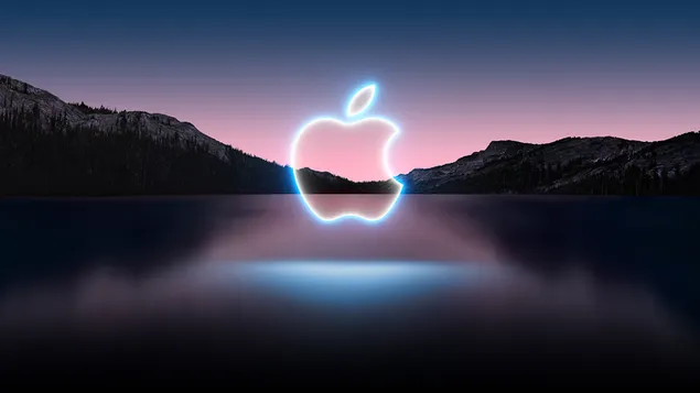 Apple logo with reflected light reflected in water in silhouette mountains at dusk