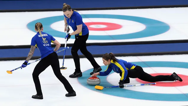 Atleter, der sender granitstenen til målet på isbanen og spillere, der fejer isen download