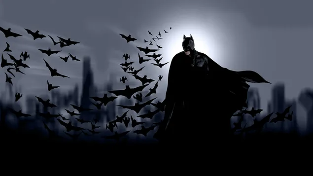 Batman flying behind him in the dark of the city download