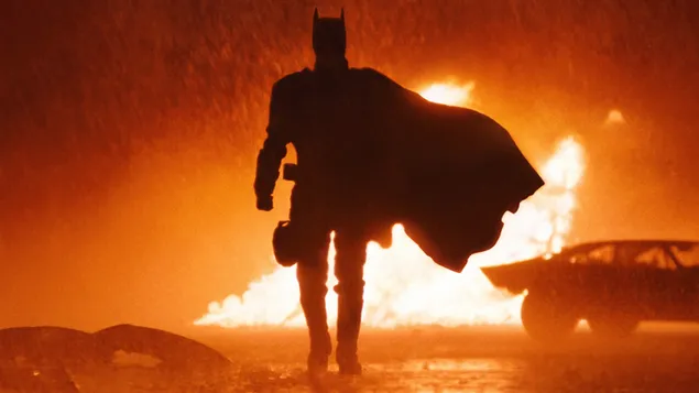 batman in the rains behind the fire