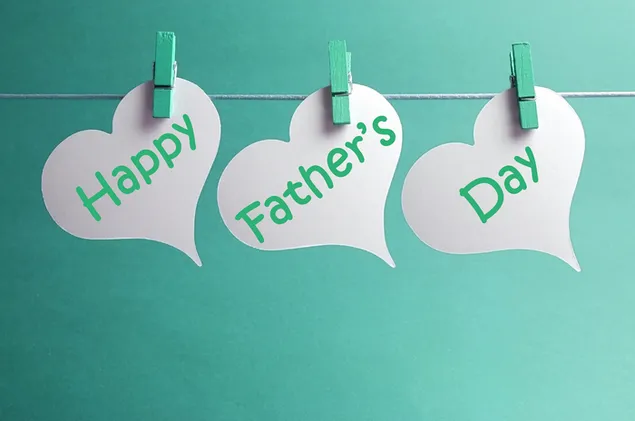 Beautiful lettering design hung with green clothespins on a green background prepared for Father's Day special celebration day