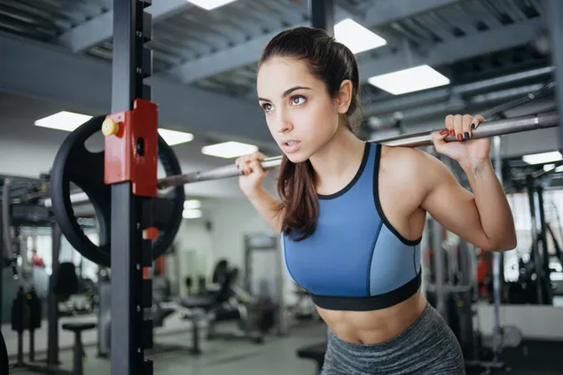 Beautiful woman is working out lifting weights 2K wallpaper