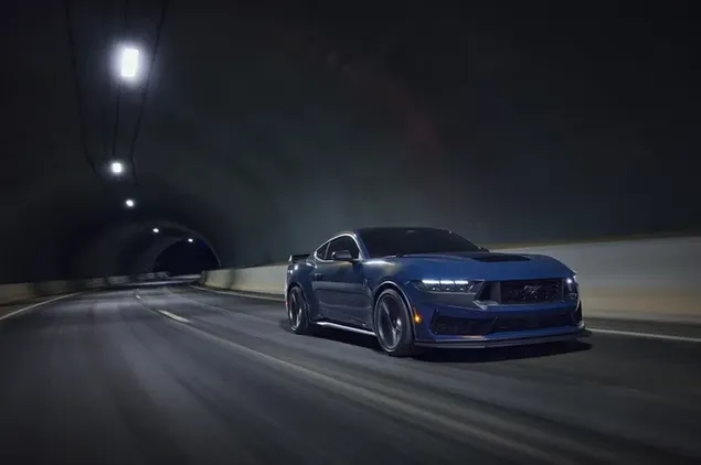Ford Mustang azul conduciendo entre luces en la carretera de asfalto por la noche 8K fondo de pantalla