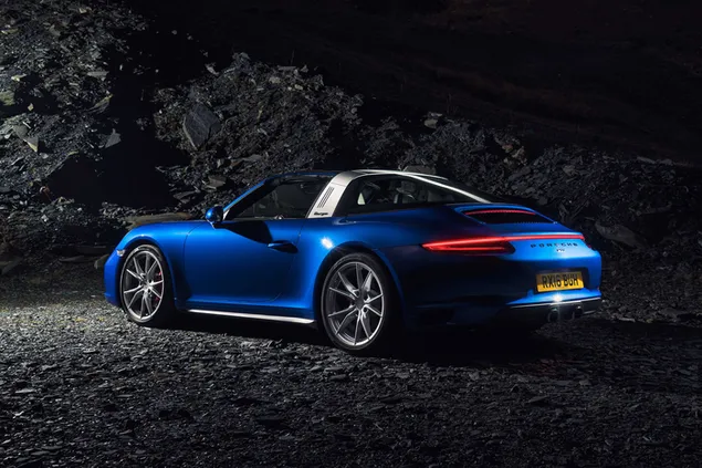 Blue Porsche side view on dirt field at night 4K wallpaper
