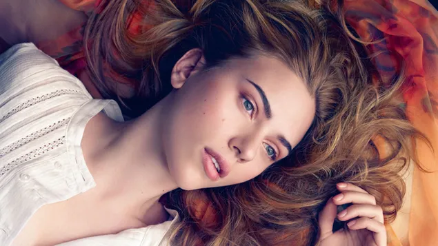 Brown hair and blue eyed Scarlett Johansson lying down