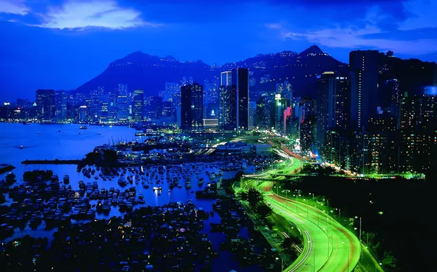 Bustling city under lights at night HD wallpaper