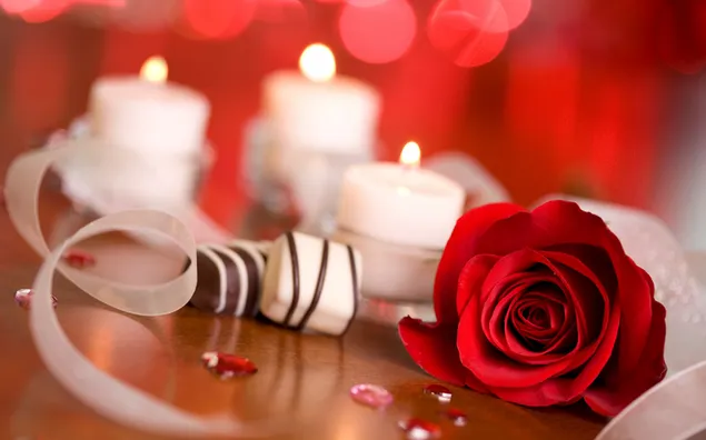 Candlelit red rose on wooden background