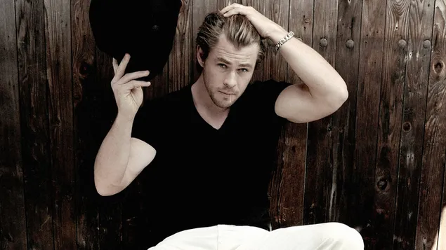 Chris Hemsworth handsome actor in white pants and black t-shirt
