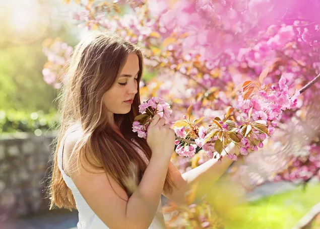 Chubby beautiful girl smelling pink flower