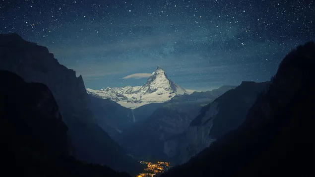 Cliffs in landscape of snowy peaks and stars