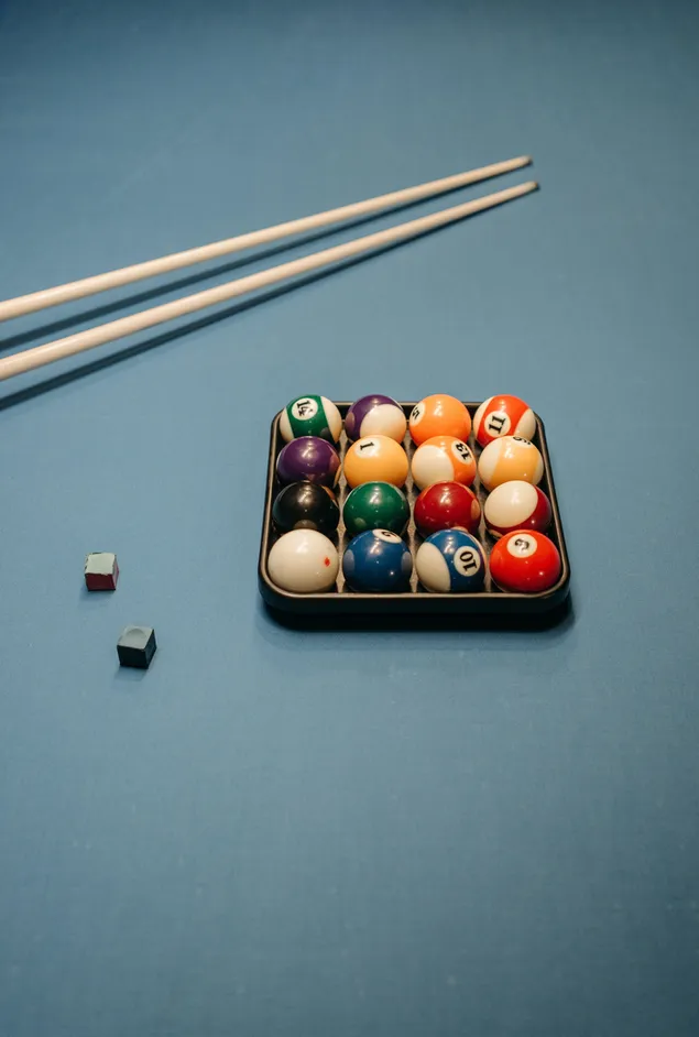 Colorful balls and cue on the pool table download