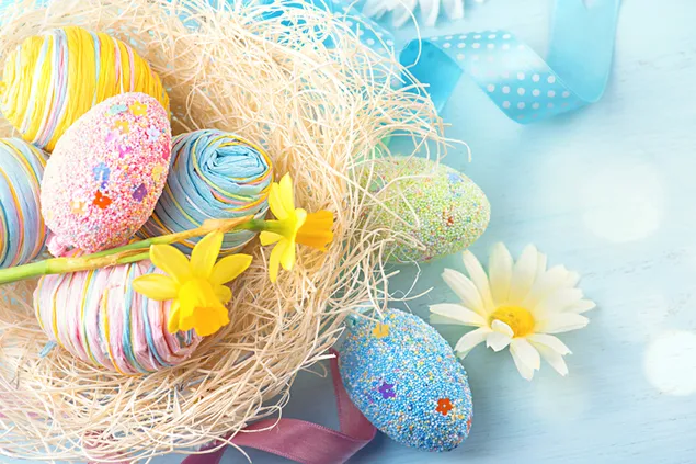 Colorful easter egg in a nest with flowers