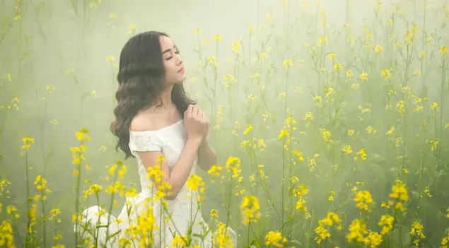 دختر آسیایی با موهای سیاه مجعد که لباسی سفید در مزرعه گل زرد پوشیده است کاغذدیواری  4K