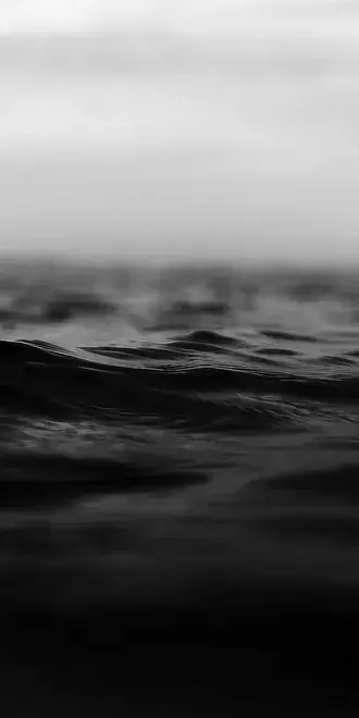 dark black and white ocean water surface with ripples and moody atmospheric vibes download
