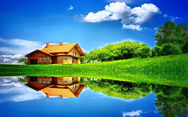 Detached house, clouds and reflection of trees in clear blue water
