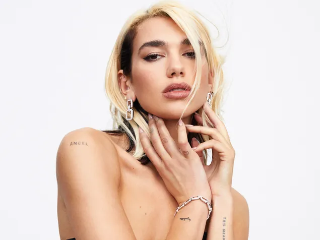Dua lipa blond hair, chain-shaped earrings with her hands in her bosom download