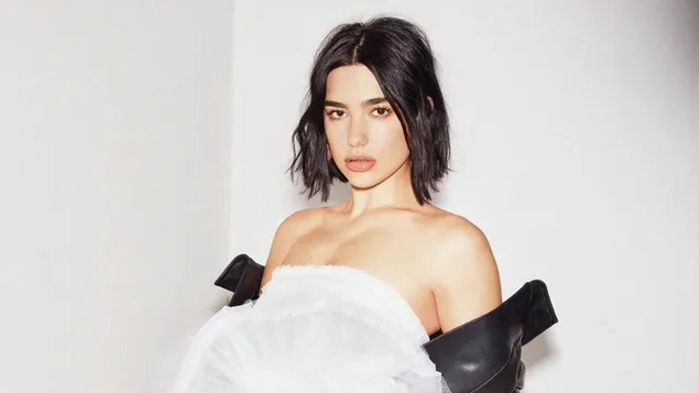 Dua lipa with her long hair and black shiny dress on a white chair HD ...