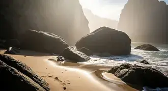 early sunlight filters through sea mist, illuminating massive rocks and soft sand on a tranquil secluded beach, where ocean waves gently meet the shor download