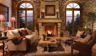 fireplace with sofa and plants and paintings