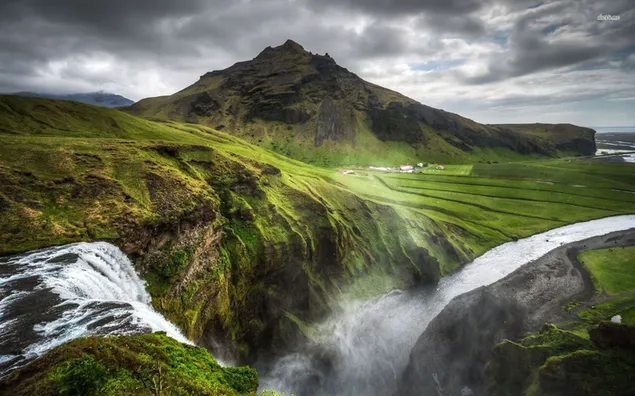 Flowing water between mountains and meadows download