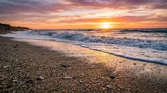 golden sunset waves on a serene beach shoreline download