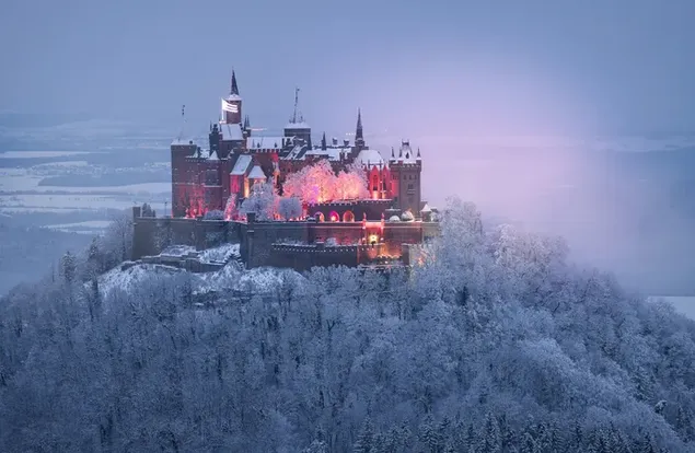 Great view of the historic Hohenzollern castle on the top of the snowy mountains