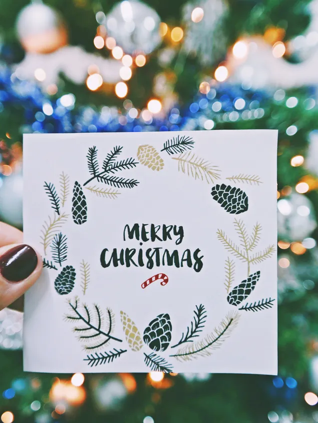 Handgeschriebene Weihnachtsgrußkarte mit Bokeh-Lichterkette im Hintergrund