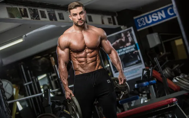 Knappe bodybuilder poseert met zijn glamoureuze spieren 2K achtergrond