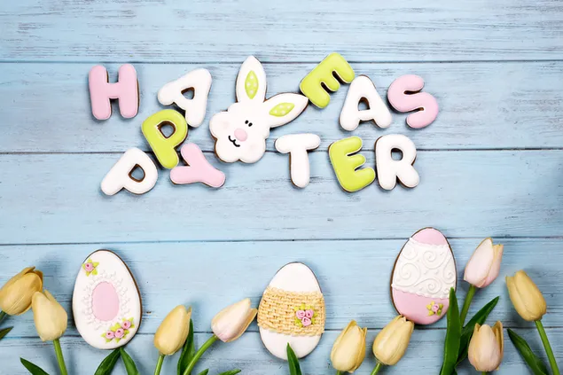 Happy Easter greetings with creative cookies and yellow tulips