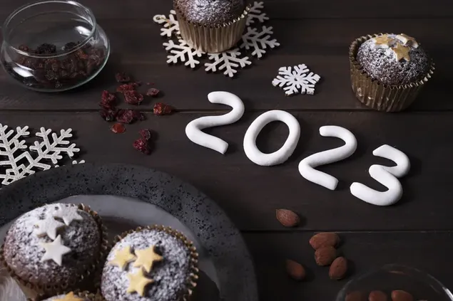 Frohes neues Jahr 2023 Kuchen und Pralinen auf Holztisch für Neujahrsfeiern zubereitet 4K Hintergrundbild