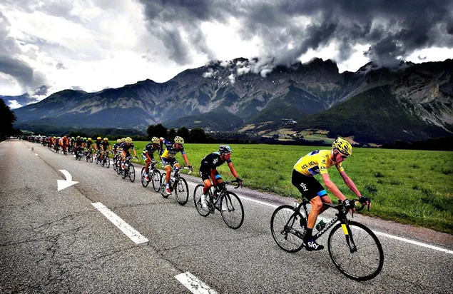 Held annually in france tour de France athletes riding on mountain and dark cloud view road 2K wallpaper