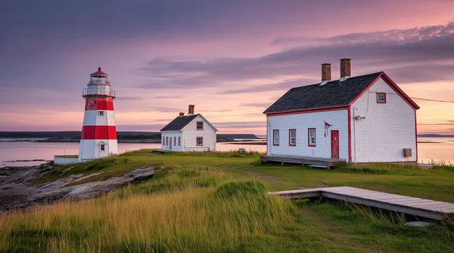 mercusuar pantai ikonik dan rumah-rumah di senja di tepi pantai unduhan