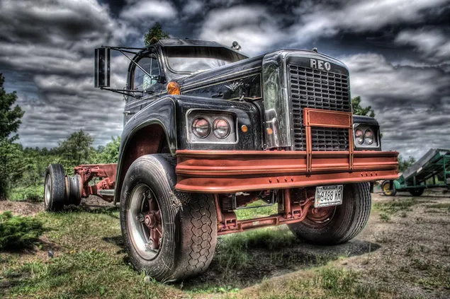Imposing stance of a vintage pickup truck on a dirt road in heavy cloudy weather 2K wallpaper