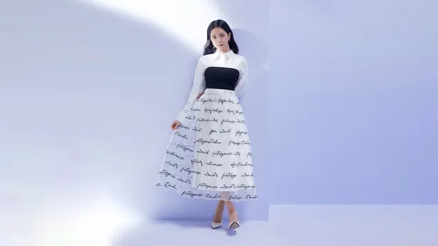 Jisoo posing holding her skirt in a black and white dress 