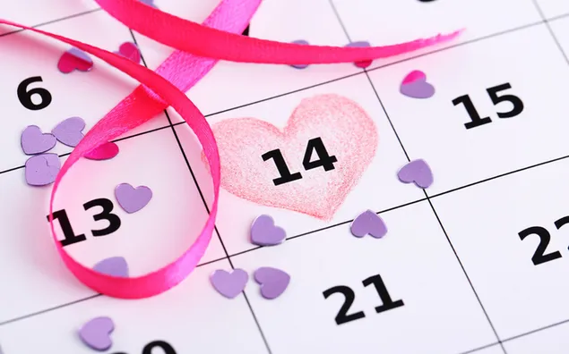 カレンダーの背景にピンクのリボンと紫の小さなハート