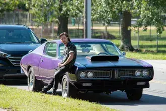 Kyle Gallner sitzt auf einem Auto – Scream-Film 2K Hintergrundbild