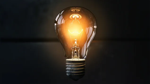 Light bulb burning in front of dark background