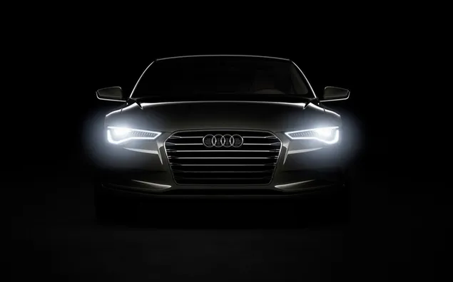 Audi abu-abu muda dengan lampu depan di area gelap unduhan