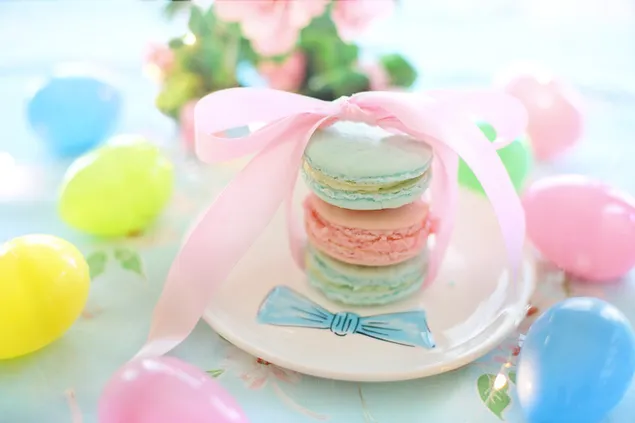 Light green and pink Macaroons tied with a pink ribbon with Easter eggs